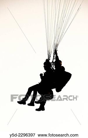Tandem paragliding flight, side view. View Large Photo Image Stock Photo - Tandem paragliding flight, side view.. Fotosearch