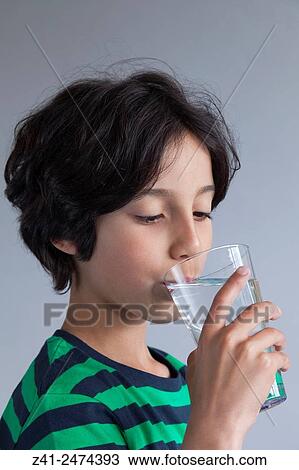 Teenage boy drinking a glass of water. View Large Photo Image Stock Image - Teenage boy drinking a glass of water.. Fotosearch