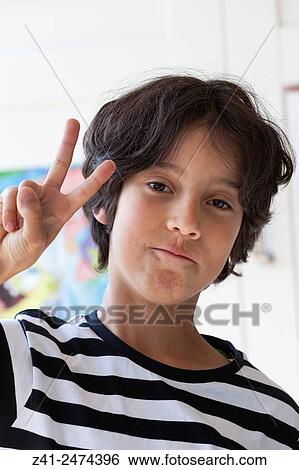 Ten year old boy making a V sign withhis fingers,. View Large Photo Image Stock Photograph - Ten year old boy making a V sign withhis fingers,.. Fotosearch