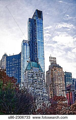 Stock Image - The Changing Skyline of Central Park South, New York City. Three new skyscrapers featuring exclusive, very expensive apartments.. Fotosearch