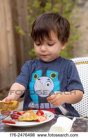 three year old boy eating his favorite food, french toast with powdered sugar and strawberries, mr# 6302. View Large Photo Image Stock Photo - three year old boy eating his favorite food, french toast with powdered sugar and strawberries, mr# 6302.. Fotosearch