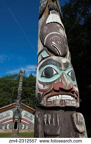 Tlingit totem pole with clan house in the background at the Totem Bight State Historical Park in Ketchikan, Southeast Alaska, USA. View Large Photo Image Stock Photo - Tlingit totem pole with clan house in the background at the Totem Bight State Historical Park in Ketchikan, Southeast Alaska, USA.. Fotosearch
