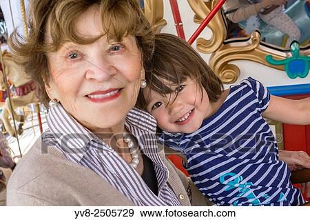 Toddler girl with her great-grandmother at the merry-go-round, San Diego, California. View Large Photo Image Stock Photo - Toddler girl with her great-grandmother at the merry-go-round, San Diego, California.. Fotosearch