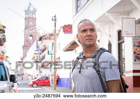 Tourist in Puerto Vallarta, Mexico. Man with backpack, 55 years old, hispanic ethnicity. View Large Photo Image Picture - Tourist in Puerto Vallarta, Mexico. Man with backpack, 55 years old, hispanic ethnicity.. Fotosearch