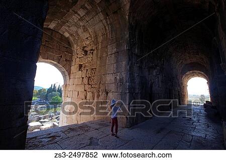 Tourist on a passageway leading to the ancient amphitheater of Miletus, Milet, Aydin Province, Turkey, Europe. View Large Photo Image Stock Image - Tourist on a passageway leading to the ancient amphitheater of Miletus, Milet, Aydin Province, Turkey, Europe.. Fotosearch