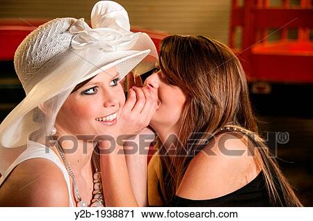 Two female models sitting on antique red automobile talking and whispering View Large Photo Image Stock Image - Two female models sitting on antique red automobile talking and whispering. Fotosearch