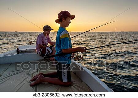Two Young British Tourists On A Sunset Fishing Trip, Goa, India. View Large Photo Image Stock Image - Two Young British Tourists On A Sunset Fishing Trip, Goa, India.. Fotosearch
