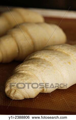 uncooked croissants on a baking mat ready to go in oven. View Large Photo Image Stock Photograph - uncooked croissants on a baking mat ready to go in oven.. Fotosearch