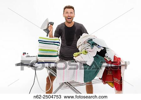 Very sweaty man, Goes berserk behind an ironing board full of clothing. View Large Photo Image Stock Image - Very sweaty man, Goes berserk behind an ironing board full of clothing.. Fotosearch