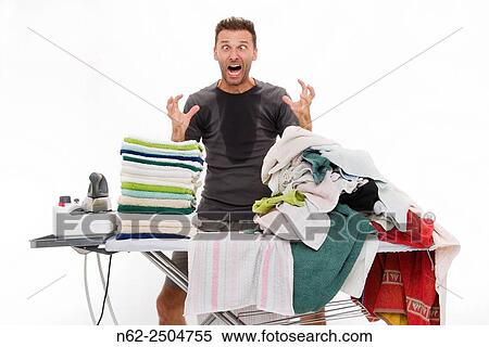 Very sweaty man, Goes berserk behind an ironing board full of clothing. View Large Photo Image Stock Photography - Very sweaty man, Goes berserk behind an ironing board full of clothing.. Fotosearch