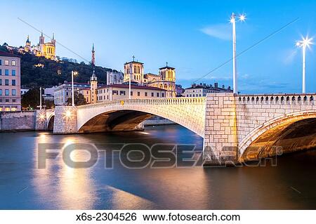 Stock Photograph - View of the Cathedral of St-Jean and the Bonaparte bridge in Lyon, Rhône, Rhône-Alpes, France.. Fotosearch