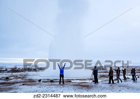 Visitors watching the famous Strokkur geyser wich erupts about every 4–8 minutes. Geysir. Haukadalur. Iceland. View Large Photo Image Stock Photo - Visitors watching the famous Strokkur geyser wich erupts about every 4–8 minutes. Geysir. Haukadalur. Iceland.. Fotosearch