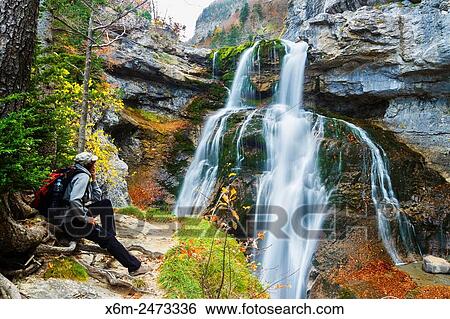 Stock Photograph - Waterfall in Estrecho cave. Ordesa Valley. Ordesa National Park. Pyrenees, Huesca, Spain, Europe.. Fotosearch