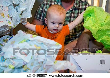 Wheat Ridge, Colorado - Little boy´s first birthday. He discovered that the wrapping paper was the best part of his birthday presents. View Large Photo Image Stock Photo - Wheat Ridge, Colorado - Little boy´s first birthday. He discovered that the wrapping paper was the best part of his birthday presents.. Fotosearch
