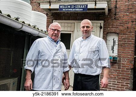 Stock Image - Willem II Straat, Tilburg, Netherlands. Father and son LeJeune are third 3rd and fourth 4th generation butchers at their butchery, established in 1902, by the son´s great grandfather.. Fotosearch