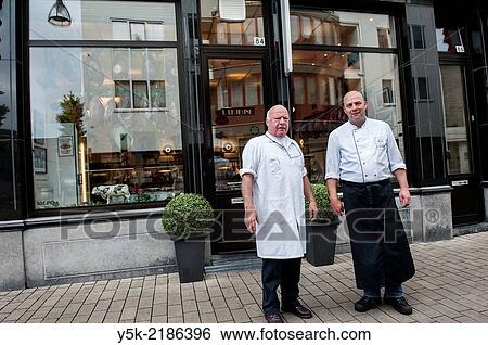 Stock Photograph - Willem II Straat, Tilburg, Netherlands. Father and son LeJeune are third 3rd and fourth 4th generation butchers at their butchery, established in 1902, by the son´s great grandfather.. Fotosearch