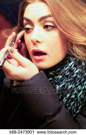 Woman, 19, puts on eye make up View Large Photo Image Stock Image - Woman, 19, puts on eye make up. Fotosearch