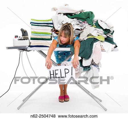 Woman bent over a board covered with a lot of clothes, displays a sign reading aid. View Large Photo Image Stock Photo - Woman bent over a board covered with a lot of clothes, displays a sign reading aid.. Fotosearch
