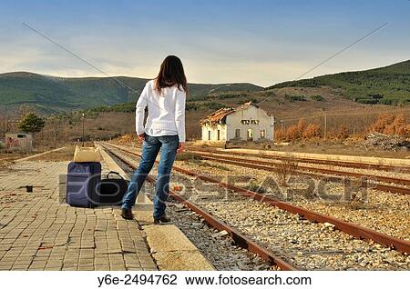 Stock Image - Woman in railway station. Buitrago de Lozoya, Madrid province, Spain. Fotosearch