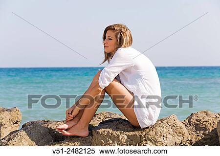Woman relaxing by the sea View Large Photo Image Stock Photography - Woman relaxing by the sea. Fotosearch