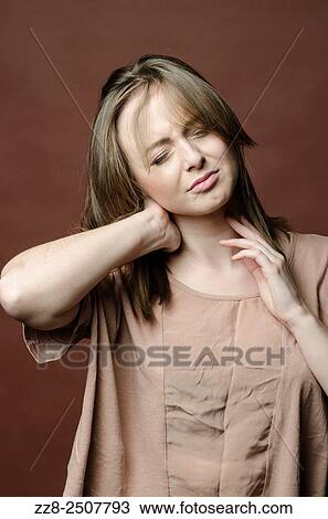 Stock Image - Woman with pain in the neck.. Fotosearch