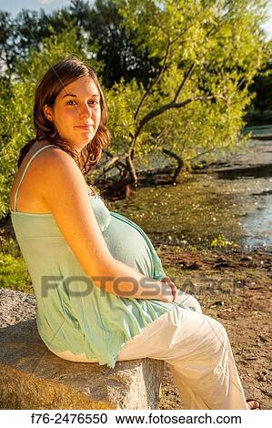 young 8 and a half month along, pregnant woman outdoors, mr G070106-2. View Large Photo Image Stock Image - young 8 and a half month along, pregnant woman outdoors, mr G070106-2.. Fotosearch