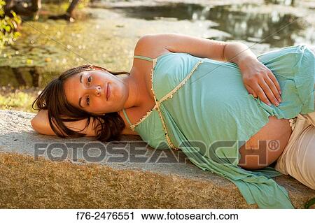 young 8 and a half month along, pregnant woman outdoors, mr# G070106_2. View Large Photo Image Stock Image - young 8 and a half month along, pregnant woman outdoors, mr# G070106_2.. Fotosearch