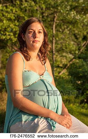 young 8 and a half month along, pregnant woman outdoors, mr# G070106_2. View Large Photo Image Stock Image - young 8 and a half month along, pregnant woman outdoors, mr# G070106_2.. Fotosearch