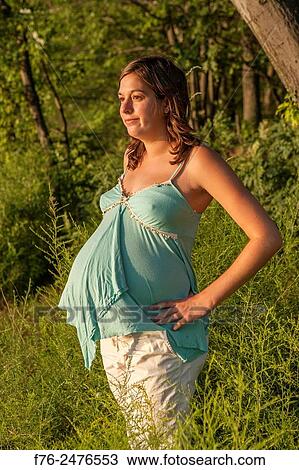 young 8 and a half month along, pregnant woman outdoors, mr# G070106_2. View Large Photo Image Stock Image - young 8 and a half month along, pregnant woman outdoors, mr# G070106_2.. Fotosearch
