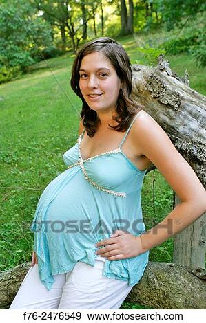 young 8 and a half month along, pregnant woman outdoors, mr G070106-2. View Large Photo Image Stock Photo - young 8 and a half month along, pregnant woman outdoors, mr G070106-2.. Fotosearch