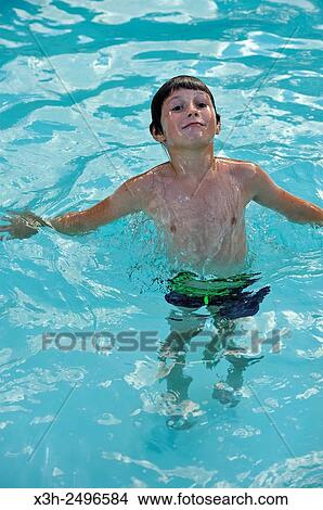 young boy in swimming pool, Ile-de-France, France, Europe. View Large Photo Image Picture - young boy in swimming pool, Ile-de-France, France, Europe.. Fotosearch