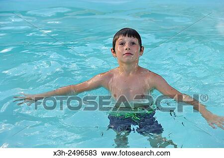 young boy in swimming pool, Ile-de-France, France, Europe. View Large Photo Image Stock Image - young boy in swimming pool, Ile-de-France, France, Europe.. Fotosearch