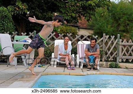young boy jumping into swimming pool, Ile-de-France, France, Europe. View Large Photo Image Stock Photography - young boy jumping into swimming pool, Ile-de-France, France, Europe.. Fotosearch