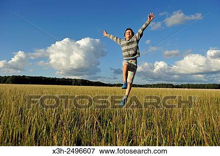 young boy running and jumping in a field, Ile-de-France, France, Europe. View Large Photo Image Stock Photo - young boy running and jumping in a field, Ile-de-France, France, Europe.. Fotosearch
