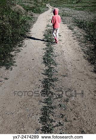 Stock Photo - Young child walking along a path.. Fotosearch