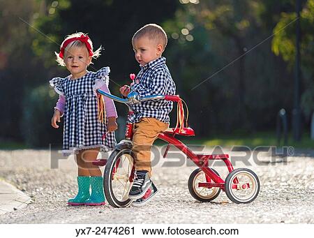 Young children playing outdoors. View Large Photo Image Stock Image - Young children playing outdoors.. Fotosearch