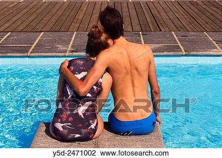 young couple at poolside, summer vacation View Large Photo Image Stock Image - young couple at poolside, summer vacation. Fotosearch
