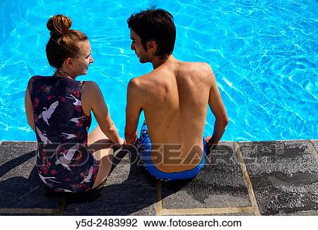young couple at poolside, summer vacation View Large Photo Image Stock Image - young couple at poolside, summer vacation. Fotosearch