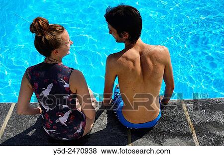 young couple at poolside, summer vacation View Large Photo Image Stock Photo - young couple at poolside, summer vacation. Fotosearch