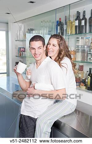 Young couple having breaksfast in the kitchen in the morning View Large Photo Image Stock Image - Young couple having breaksfast in the kitchen in the morning. Fotosearch