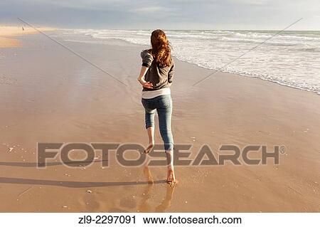Young girl running on beach at sunset, Playa El Palmar, Cadiz, Spain View Large Photo Image Stock Image - Young girl running on beach at sunset, Playa El Palmar, Cadiz, Spain. Fotosearch
