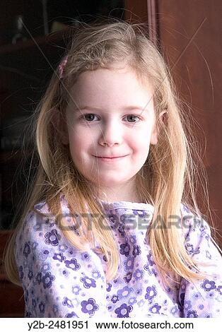 Young girl with long blond hair smiles shyly View Large Photo Image Stock Image - Young girl with long blond hair smiles shyly. Fotosearch
