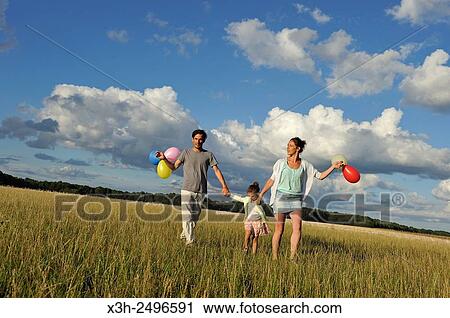 young parents playing with their child in a field, Ile-de-France, France, Europe. View Large Photo Image Stock Image - young parents playing with their child in a field, Ile-de-France, France, Europe.. Fotosearch