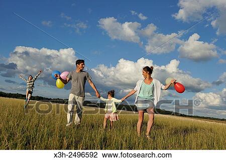 young parents playing with their children in a field, Ile-de-France, France, Europe. View Large Photo Image Stock Image - young parents playing with their children in a field, Ile-de-France, France, Europe.. Fotosearch