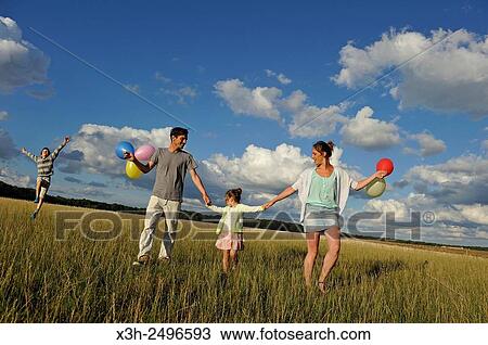 young parents playing with their children in a field, Ile-de-France, France, Europe. View Large Photo Image Stock Image - young parents playing with their children in a field, Ile-de-France, France, Europe.. Fotosearch