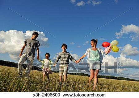 young parents playing with their children in a field, Ile-de-France, France, Europe. View Large Photo Image Stock Image - young parents playing with their children in a field, Ile-de-France, France, Europe.. Fotosearch
