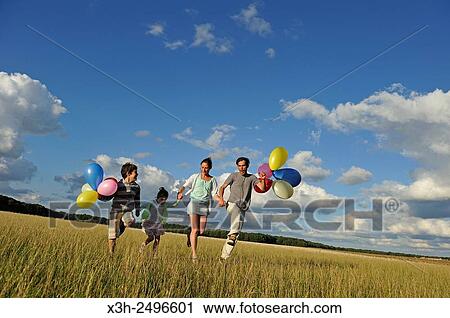 young parents playing with their children in a field, Ile-de-France, France, Europe. View Large Photo Image Stock Image - young parents playing with their children in a field, Ile-de-France, France, Europe.. Fotosearch