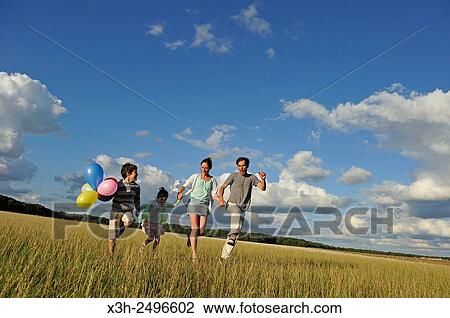young parents playing with their children in a field, Ile-de-France, France, Europe. View Large Photo Image Stock Image - young parents playing with their children in a field, Ile-de-France, France, Europe.. Fotosearch