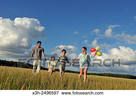 young parents playing with their children in a field, Ile-de-France, France, Europe. View Large Photo Image Stock Photo - young parents playing with their children in a field, Ile-de-France, France, Europe.. Fotosearch