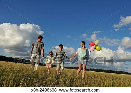 young parents playing with their children in a field, Ile-de-France, France, Europe. View Large Photo Image Stock Photo - young parents playing with their children in a field, Ile-de-France, France, Europe.. Fotosearch